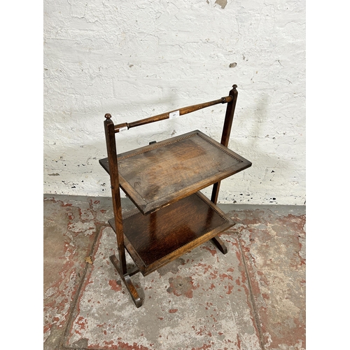 127 - An early 20th century beaded oak two tier folding side table