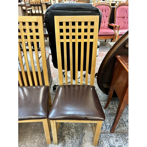 129 - A set of four modern oak and brown leatherette dining chairs