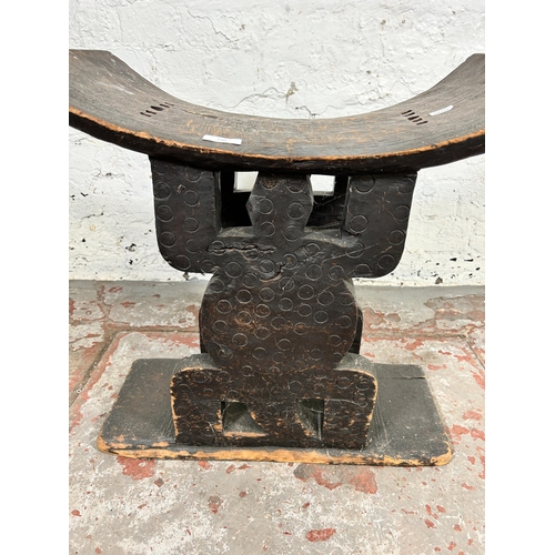 130 - An African tribal carved hardwood stool