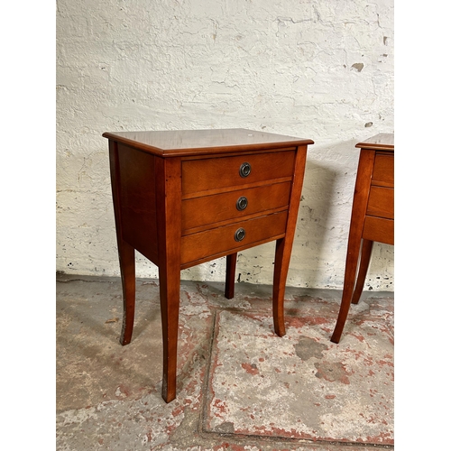 131 - A pair of Regency style inlaid mahogany effect bedside chests of three drawers