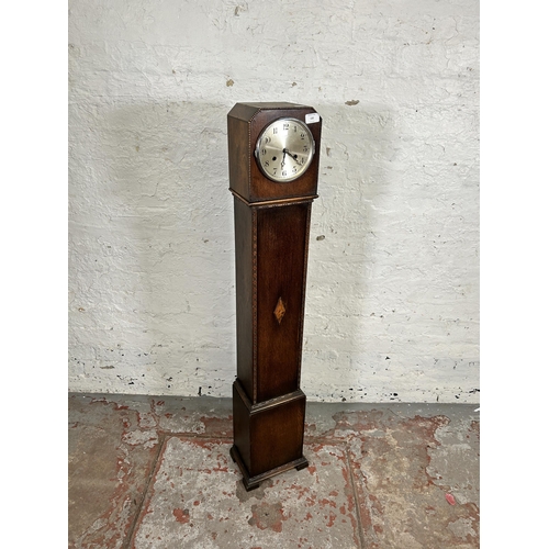 132 - A 1930s oak cased chiming granddaughter clock - approx. 126cm high