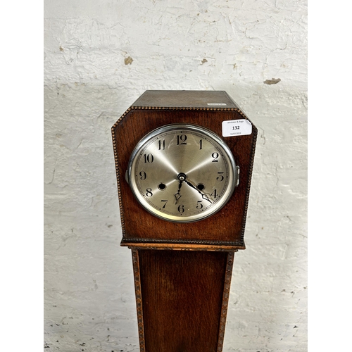 132 - A 1930s oak cased chiming granddaughter clock - approx. 126cm high