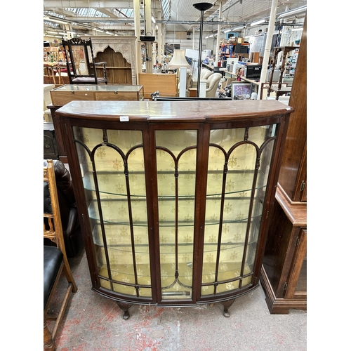 134 - An early 20th century mahogany display cabinet with two glazed doors and cabriole supports