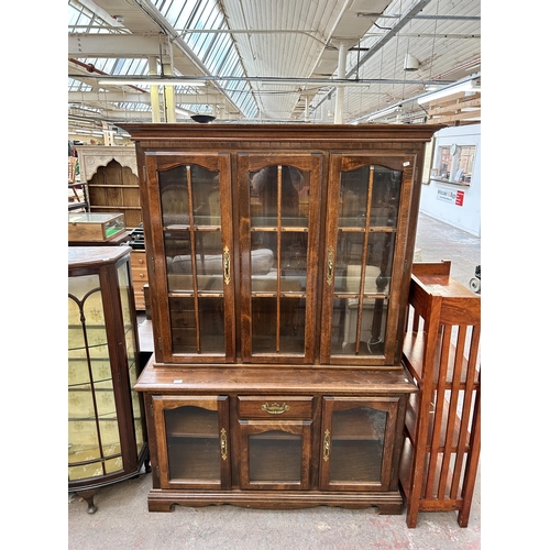 135 - A Georgian style beech display cabinet with two upper glazed doors, two lower glazed doors and singl... 