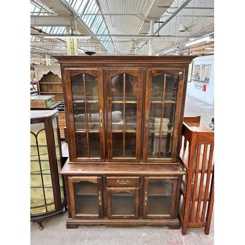 135 - A Georgian style beech display cabinet with two upper glazed doors, two lower glazed doors and singl... 