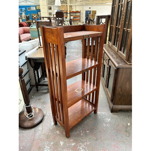 136 - A mahogany four tier folding shelving unit