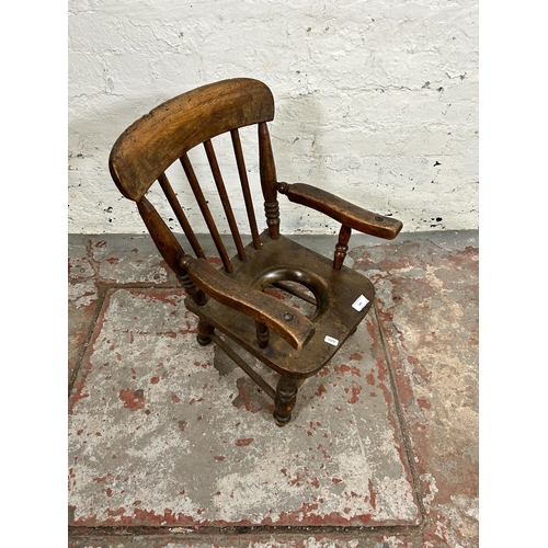 142 - A Victorian beech child's commode armchair