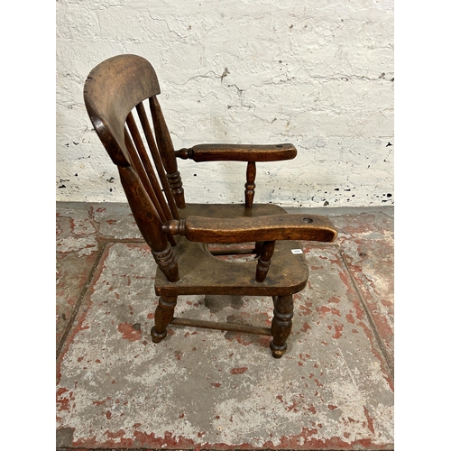 142 - A Victorian beech child's commode armchair