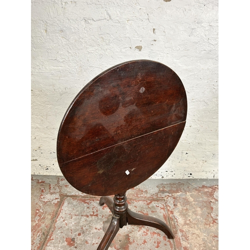 143 - A Georgian oak circular tilt top occasional table on tripod pedestal support