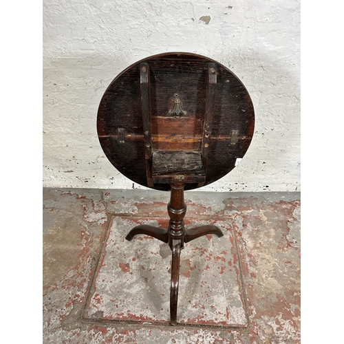 143 - A Georgian oak circular tilt top occasional table on tripod pedestal support