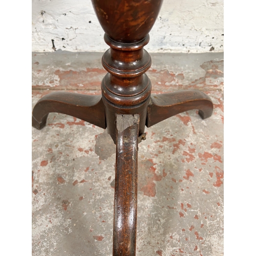 143 - A Georgian oak circular tilt top occasional table on tripod pedestal support