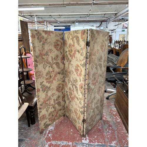 148 - An early 20th century floral fabric three section folding dressing screen