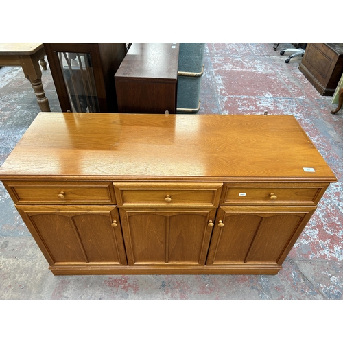 150 - A Stag teak sideboard with three drawers and three cupboard doors