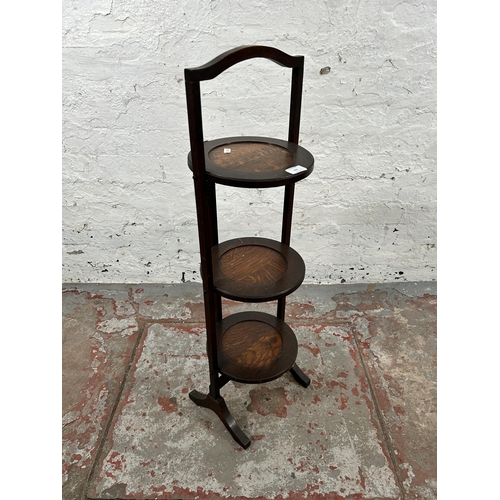 155 - An early 20th century oak three tier folding cake stand