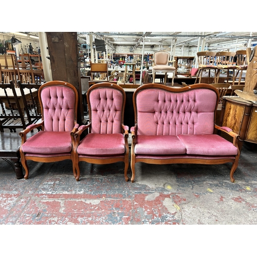 157 - A French style beech and pink fabric upholstered three piece lounge suite comprising two seater sofa... 