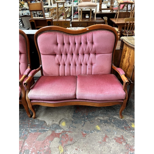 157 - A French style beech and pink fabric upholstered three piece lounge suite comprising two seater sofa... 