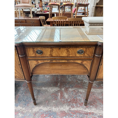 160 - A Regency style mahogany bow fronted sideboard with two cupboard doors and two drawers