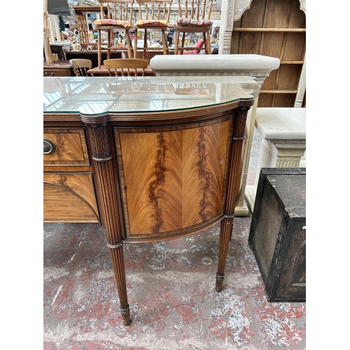 160 - A Regency style mahogany bow fronted sideboard with two cupboard doors and two drawers