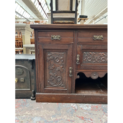 163 - An Edwardian carved mahogany sideboard with three drawers and three cupboard doors