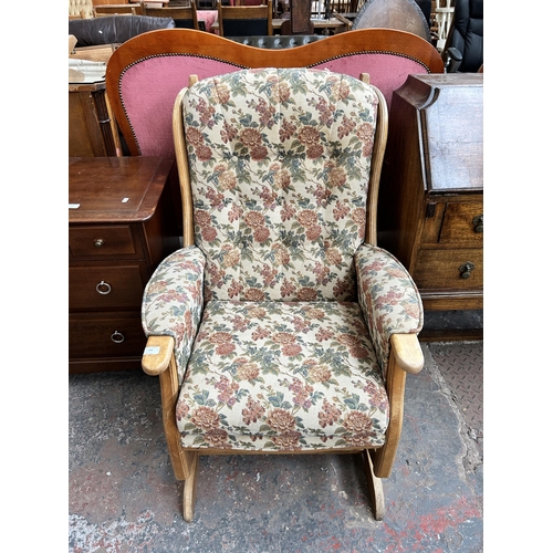 174 - A beech and tapestry upholstered rocking armchair