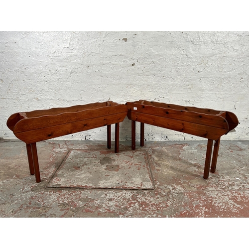 195 - A pair of stained pine free standing garden troughs