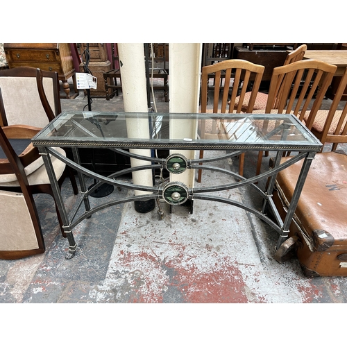 196 - A wrought iron and glass rectangular console table with lion mask design and paw feet