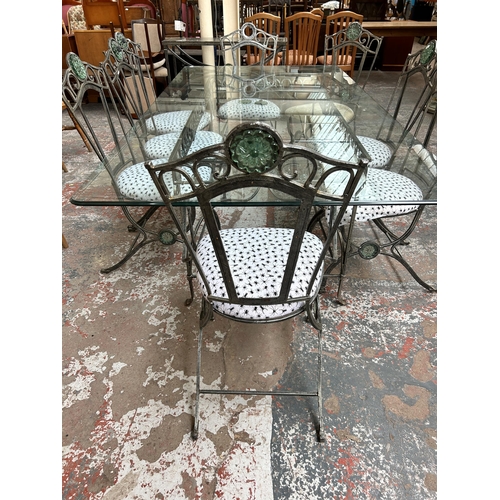 199 - A wrought iron and glass rectangular dining table and eight matching chairs