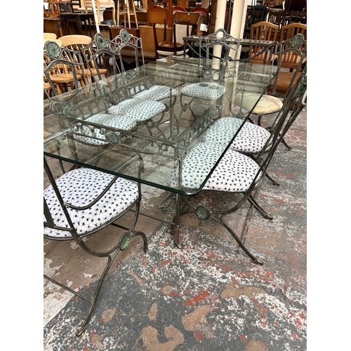 199 - A wrought iron and glass rectangular dining table and eight matching chairs