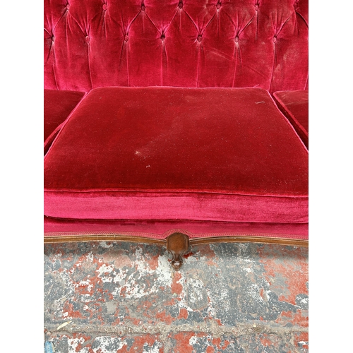 205 - A Victorian style mahogany and red fabric upholstered three seater parlour sofa