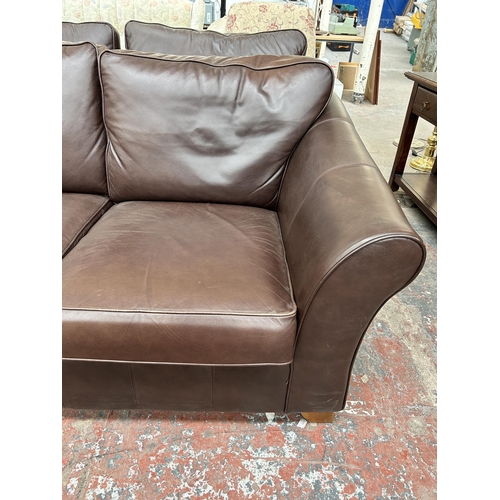 209 - A Marks & Spencer brown leather two seater sofa