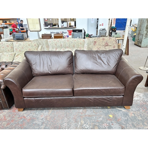 210 - A Marks & Spencer brown leather three seater sofa