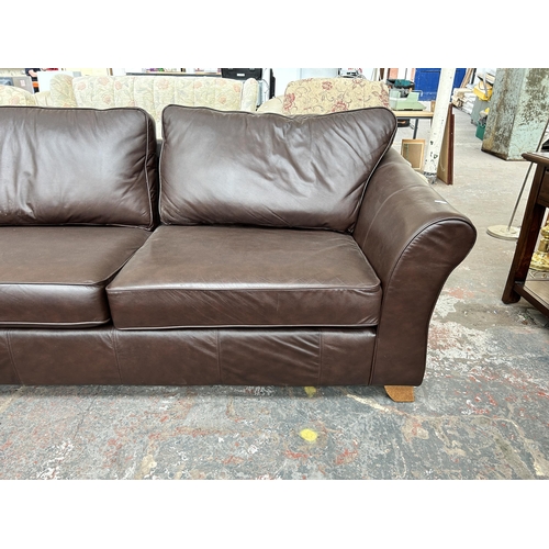 210 - A Marks & Spencer brown leather three seater sofa