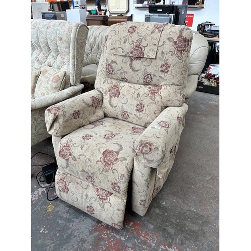 212 - A floral upholstered electric reclining armchair with remote and power supply