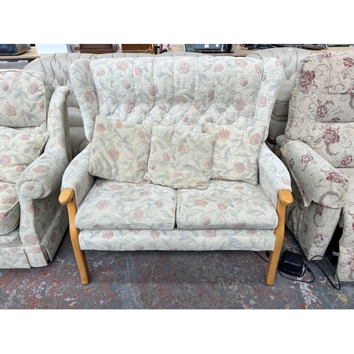 212A - Two floral upholstered two seater sofas