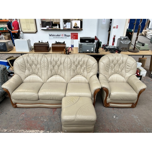 212B - A cream leather three piece lounge suite comprising three seater sofa, armchair and footstool