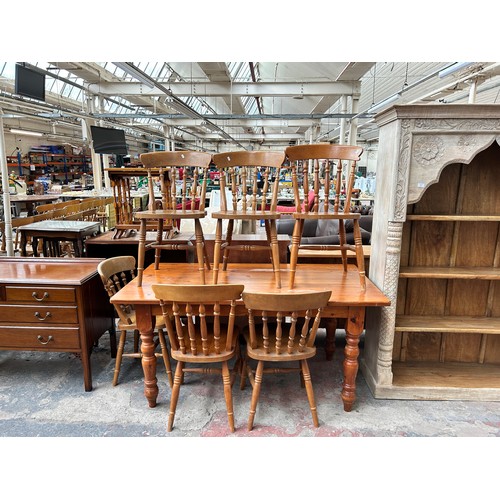 185 - A pine farmhouse dining table with six beech dining chairs