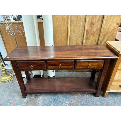 191 - An Indian sheesham wood three drawer console table