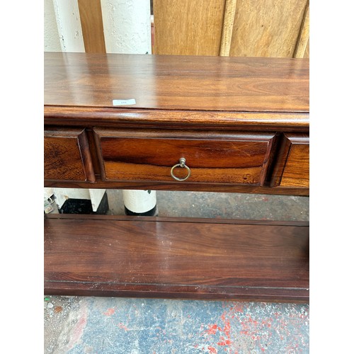 191 - An Indian sheesham wood three drawer console table