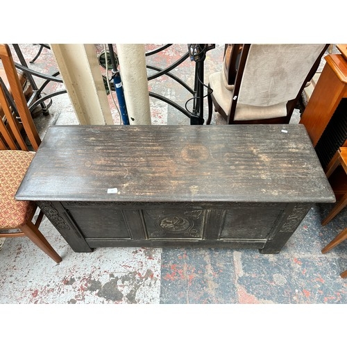 181 - A 17th century style carved oak blanket box