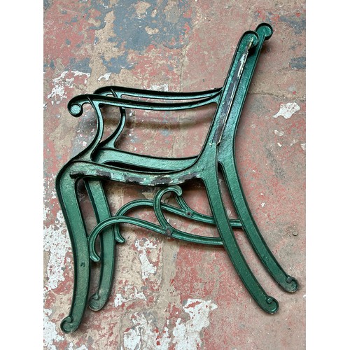 865 - A pair of cast iron garden bench ends