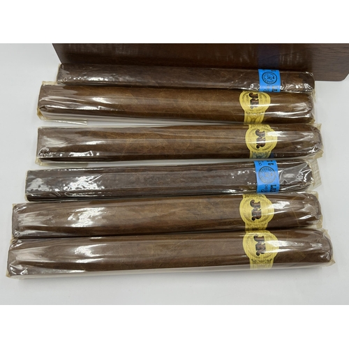 2276 - Six sealed cigars, four JR hand made imported and two Racine & Laramie together with oak box with ba... 