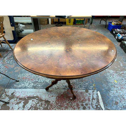 200 - An Italian style inlaid walnut effect circular pedestal dining table