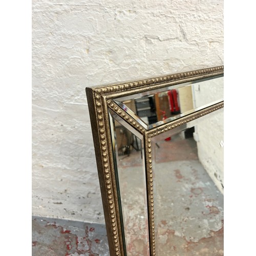 213 - A modern framed bevelled edge wall mirror - approx. 82cm high x 113 cm wide