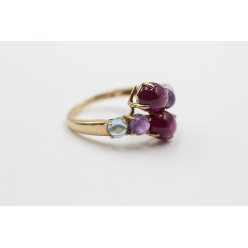 2005 - A 9ct gold garnet, amethyst and topaz bypass ring - approx. gross weight 3.1g