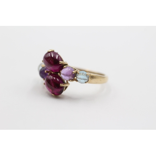 2005 - A 9ct gold garnet, amethyst and topaz bypass ring - approx. gross weight 3.1g