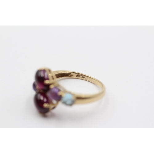 2005 - A 9ct gold garnet, amethyst and topaz bypass ring - approx. gross weight 3.1g