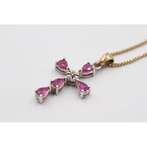 2032 - A 9ct white and yellow gold diamond and ruby cross pendant on chain - approx. gross weight 3.5g