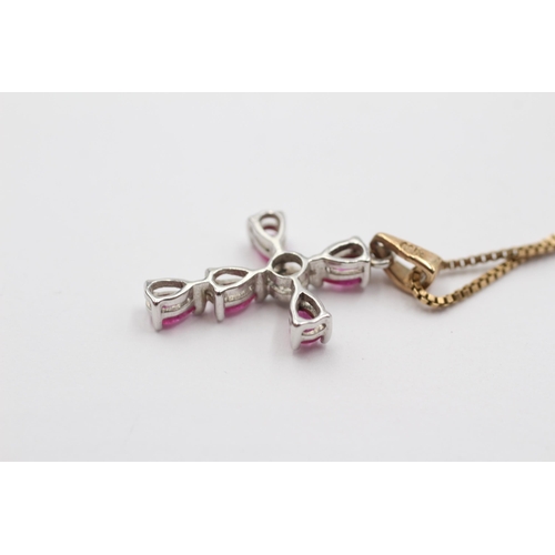 2032 - A 9ct white and yellow gold diamond and ruby cross pendant on chain - approx. gross weight 3.5g