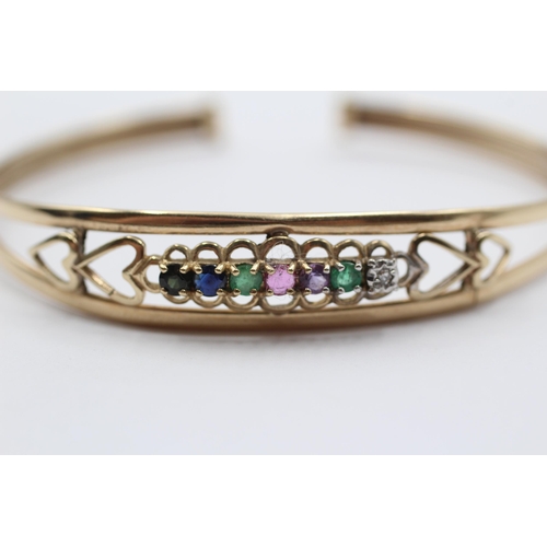 2034 - A 9ct gold diamond, emerald, amethyst, ruby, sapphire and tanzanite 'Dearest' acrostic bangle - appr... 