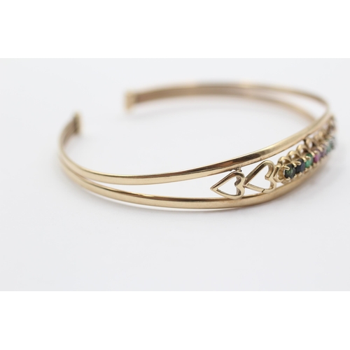 2034 - A 9ct gold diamond, emerald, amethyst, ruby, sapphire and tanzanite 'Dearest' acrostic bangle - appr... 